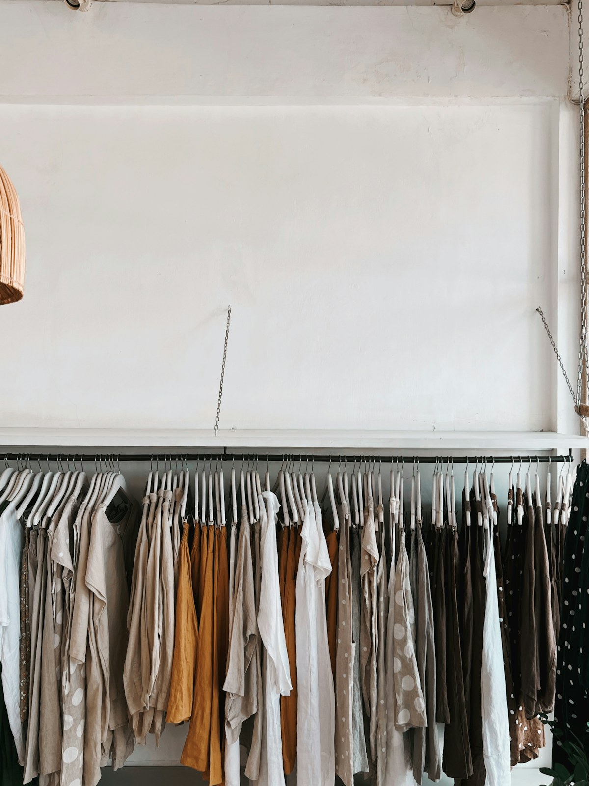 Neutral garments arranged on a clothing rack